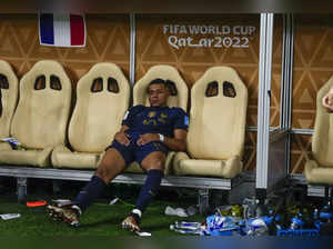 France's Kylian Mbappe sits on the bench at the end of the World Cup final socce...