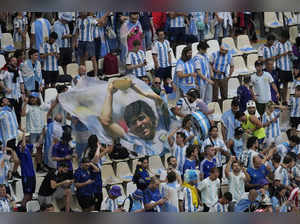 Argentina's fans display a flag with a photo of Maradona before the World Cup fi...