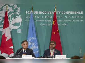 Huang Runqiu, left, President of the COP 15 and Minister of Ecology and Environm...