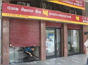 New Delhi: An employee comes out as Punjab National Bank pulls down the shutters during two day bank strike spearheaded by the United Forum of Bank Unions (UFBU), an umbrella body of nine unions; in New Delhi on May 30, 2018. The bankers are striking work demanding early revision of the wages. The wage revision has been due since November 1, 2017. (Photo: IANS)