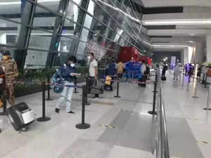 New Delhi: Passengers follow social distancing norms at they enter Indira Gandhi International Airport via Terminal 3 after India resumed civil passenger flight services on Monday, exactly two-months after it had suspended these operations due to the outbreak of Covid-19, in New Delhi on May 25, 2020. (Photo: IANS)