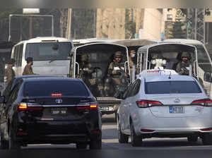 Islamabad: A special unit of national security forces escort a convoy of vehicle...
