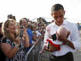 US President Obama holds a baby in Massachusetts