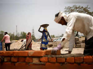 Labourers work at a construction site on a hot summer day in New Delhi
