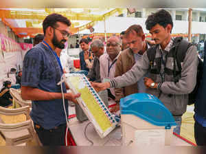 Rajkot: Polling officials collect EVMs and other election equipment at a distrib...
