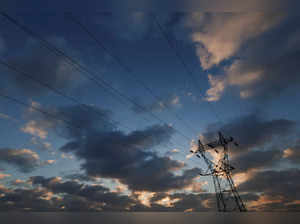 An electrical power pylon of high-voltage electrical power lines is seen during sunset