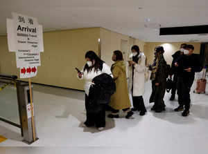 Passengers on a plane from China’s capital Beijing arrive and head to the coronavirus disease (COVID-19) test area at Narita international airport in Narita