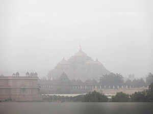 New Delhi, Jan 20 (ANI): Akshardham Temple is covered in dense fog on a cold win...