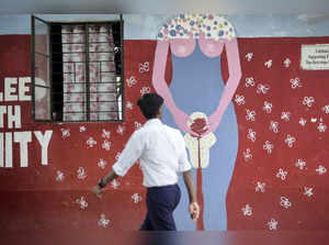 Guwahati: A boy walks past a wall mural depicting female menstruation at a schoo...