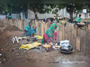 Surat: Female construction workers cook food on the eve of International Labour ...