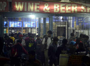 Gurugram: People buy liquor at a wine shop, Dundahera- Kapashera border, in Guru...
