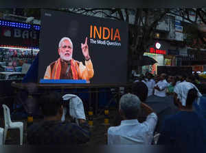 People watch the BBC documentary "India: The Modi Question", on a screen installed at the Marine Drive junction under the direction of the district Congress committee, in Kochi on January 24, 2023. India's government said it has blocked videos and tweets sharing links to a BBC documentary about Prime Minister Narendra Modi's role during deadly 2002 sectarian riots, calling it "hostile propaganda and anti-India garbage". (Photo by Arun CHANDRABOSE / AFP)