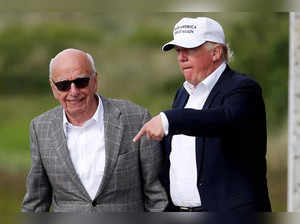 FILE PHOTO: Republican presidential candidate Donald Trump speaks to media mogul Rupert Murdoch as they walk out of Trump International Golf Links in Aberdeen