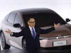 (FILES) This file photo taken on December 14, 2021 shows the president of Japanese automaker Toyota, Akio Toyoda, gesturing at a briefing on electric vehicle battery strategies at the company’s showroom in Tokyo. Toyota on January 26, 2023 said Koji Sato will become president, CEO, and operating officer, replacing third-generation chief executive Akio Toyoda who will become board chairman. (Photo by Behrouz MEHRI / AFP)
