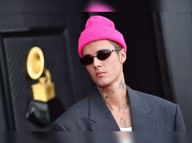 (FILES) In this file photo taken on April 03, 2022, Canadian singer and songwriter Justin Bieber arrives for the 64th Annual Grammy Awards at the MGM Grand Garden Arena in Las Vegas. Bieber has sold his shares of his music publishing and recording catalog to the Blackstone-backed Hipgnosis Songs Capital, Hipgnosis said on January 24, 2023. The sale -- which reportedly is valued at more than $200 million -- has been rumored for weeks, with the 28-year-old joining a who's who of artists, including Bruce Springsteen and Bob Dylan, who have cashed out recently on their catalogs. (Photo by ANGELA