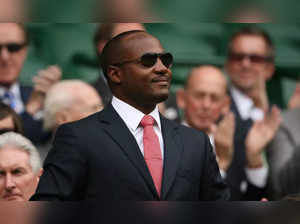 (FILES) In this file photo taken on June 26, 2010 former West Indies cricketer Brian Lara acknowledges the crowd ahead of play between US Serena Williams and Slovakia's Dominika Cibulkova during the Wimbledon Tennis Championships at the All England Tennis Club, in southwest London. Former West Indies batting star and captain Brian Lara has agreed to take on a role as 'performance mentor' with the West Indies teams and academy, Cricket West Indies (CWI) announced on January 26, 2023. (Photo by GLYN KIRK / AFP)