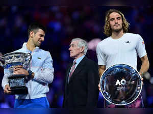 Serbia's Novak Djokovic (L) poses with the Norman Brookes Challenge Cup alongside former tennis player Ken Rosewall and Stefanos Tsitsipas (R) of Greece after their men's singles final match on day fourteen of the Australian Open tennis tournament in Melbourne on January 29, 2023. -- IMAGE RESTRICTED TO EDITORIAL USE - STRICTLY NO COMMERCIAL USE -- (Photo by MANAN VATSYAYANA / AFP) / -- IMAGE RESTRICTED TO EDITORIAL USE - STRICTLY NO COMMERCIAL USE --