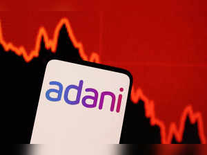 FILE PHOTO: Illustration shows Adani logo and decreasing stock graph
