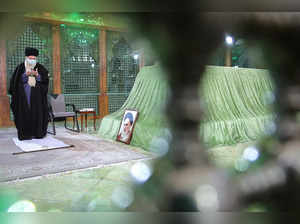 Iran's Supreme Leader Ayatollah Ali Khamenei prays at the tomb of Iran's late leader Ayatollah Ruhollah Khomeini in Tehran