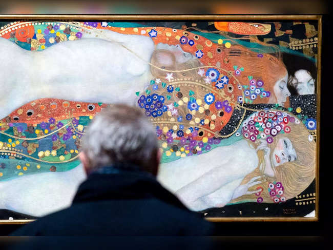 A visitor looks at the painting 'Water Serpents II' (Wasserschlangen II, 1907, on loan from HomeArt, a collection founded in Hong Kong by Rosaline Wong) by Austrian painter Gustav Klimt (1862-1918), in Vienna, Austria February 2, 2023, at The Belvedere Museum, the institution that already houses an important collection of Gustav Klimt's works.  A canvas with a turbulent history by the most famous of Austrian painters, Gustav Klimt, will be shown to the public from February 3 for the first time in nearly sixty years in his country of origin.  - RESTRICTED TO EDITORIAL USE - MANDATORY MENTION