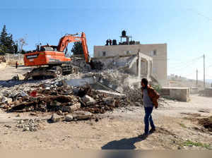 Palestinian man looks at the remains of his home in Ras al-Amud in East Jerusalem