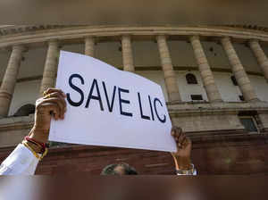 New Delhi: A member displays a placard during a protest by AAP and BRS MPs over ...
