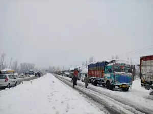 New Delhi: Trucks parked at the side of a road as Jammu-Srinagar National Highway closed due to heavy snowfall in Kashmir on Saturday, January 08, 2022.(Photo: IANS/Nisar Malik)