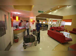 FILE PHOTO: An attendant holds a trolley at the reception are of the Tata Group's Indian Hotels Co. Ginger chain in Ahmedabad