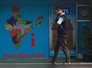 A man walks past an Indian Railway Catering And Tourism Corporation (IRCTC) office in New Delhi on February 16, 2023. (Photo by Arun SANKAR / AFP)