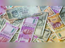 Rupee nudges higher as dollar dips; eyes on Fed minutes