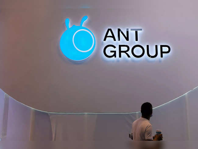 Man walks past an Ant Group logo in Shanghai