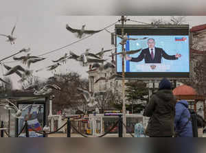 Russian President Vladimir Putin is seen on a screen during his annual address to the Federal Assembly, in Sevastopol