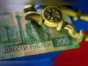 FILE PHOTO: Illustration shows natural gas pipeline, Russian Rouble banknote and flag