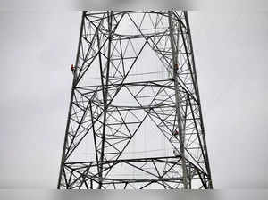 FILE PHOTO: A worker climbs an under construction power transmission tower in Munshiganj, Bangladesh