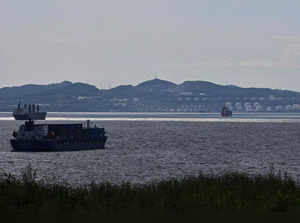 FILE PHOTO: A container ship sails along Nakhodka Bay near the oil terminal in the port city of Nakhodka