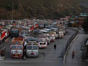 Trucks are parked near the Ambuja Cements Limited plant owned by Adani Group in Darlaghat
