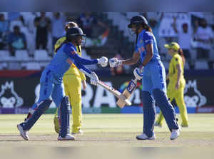 India's Jemimah Rodrigues and India's Harmanpreet Kaur congratulate each other o...