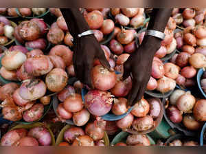 FILE PHOTO: A vendor arranges onions for sale at Mile 12 International Market in Lagos