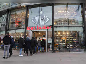 FILE PHOTO: People queue during Black Friday sales in front of a Foot Locker shoe store in Zurich