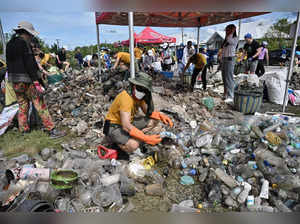(FILES) In this file photo taken on September 17, 2022 a volunteer from Trash Hero Bangkok sorts plastic waste from a mangrove area in the coastal province of Samut Prakan during World Cleanup Day. The Thai government is moving to phase out the import of plastic waste into the kingdom by 2025 after cabinet signed off on the measure. -  (Photo by Lillian SUWANRUMPHA / AFP)