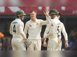 Indore: Australian bowler Matthew Kuhnemann celebrates with teammates the wicket...