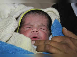 Fatmah Ahmad holds her new born baby Najm al-Din Mahmoud in Aleppo