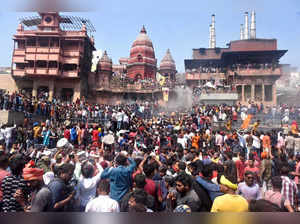 People celebrate Holi at the Manikarnika Ghat, in Varanasi