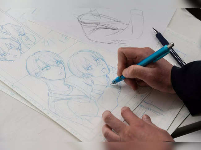 This photo taken on February 6, 2023 shows a student drawing during a manga art design class at the Tokyo Design Academy in the Harajuku area of Tokyo. The author of a sci-fi manga about to hit shelves in Japan admits he has "absolutely zero" drawing talent, so turned to artificial intelligence to create the dystopian saga.All the futuristic contraptions and creatures in "Cyberpunk: Peach John" were intricately rendered by Midjourney, a viral AI tool that has sent the art world into a spin, along with others such as Stable Diffusion and DALL-E 2. - TO GO WITH: Japan-tech-culture-manga-AI, FOCUS