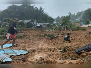 This handout photo taken and released on March 6, 2023 by the BNPB (National Disaster Management Agency) shows people inspecting the damage at a village that was hit by landslides in Natuna in Indonesia's Riau Province. RESTRICTED TO EDITORIAL USE - MANDATORY CREDIT "AFP PHOTO / BNPB (National Disaster Management Agency)" - NO MARKETING NO ADVERTISING CAMPAIGNS - DISTRIBUTED AS A SERVICE TO CLIENTS (Photo by Handout / BNPB / AFP) / RESTRICTED TO EDITORIAL USE - MANDATORY CREDIT "AFP PHOTO / BNPB (National Disaster Management Agency)" - NO MARKETING NO ADVERTISING CAMPAIGNS - DISTRIBUTED AS A SERVICE TO CLIENTS