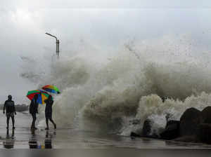 Chennai, Dec 09 (ANI): People move away as the high tides hit the Kasimedu fishi...