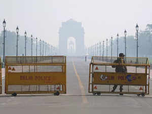 New Delhi: A security personnel stands gaurd near the India Gate amid low visibi...