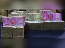 Rupee declines but ends off day's low, premiums fall