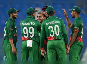 Bangladesh's cricketers congratulate teammate Mehidy Hasan Miraz (C) after he takes the wicket of England's Sam Curran (not pictured) during the third one-day international (ODI) cricket match between Bangladesh and England at the Zahur Ahmed Chowdhury Stadium in Chittagong on March 6, 2023. (Photo by Munir uz ZAMAN / AFP)