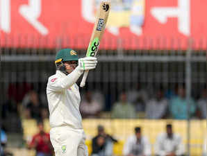 Indore: Australia's Usman Khawaja raises his bat to celebrate his half-century during the first day of third cricket test match between India and Australia in Indore on Wednesday, March 1, 2023.(Photo:Raj Kumar/IANS)
